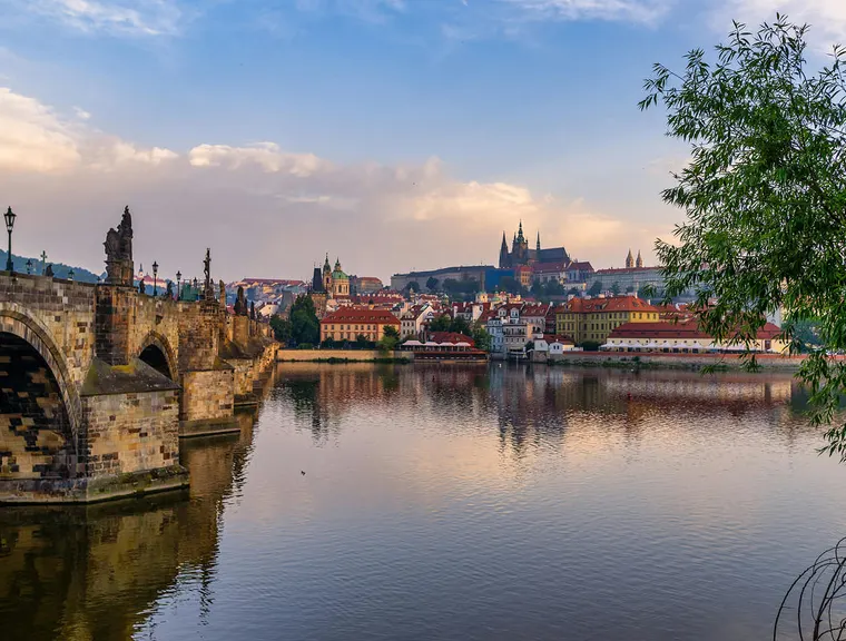 Charles Bridge and Prague Castle across the Vltava river at sunrise